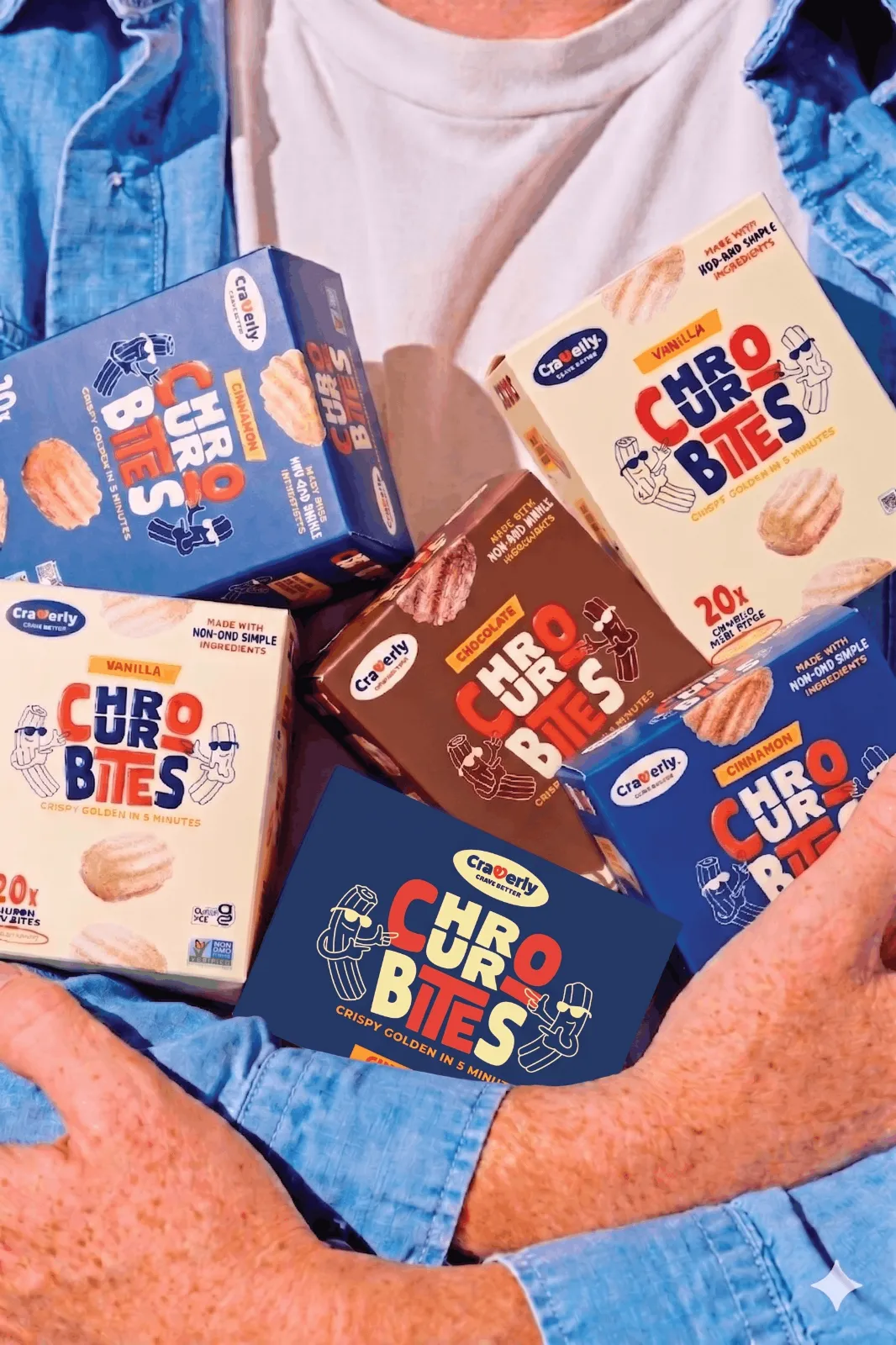 Arms full of Craverly Churro Bites boxes in all three flavors — Cinnamon, Vanilla and Chocolate